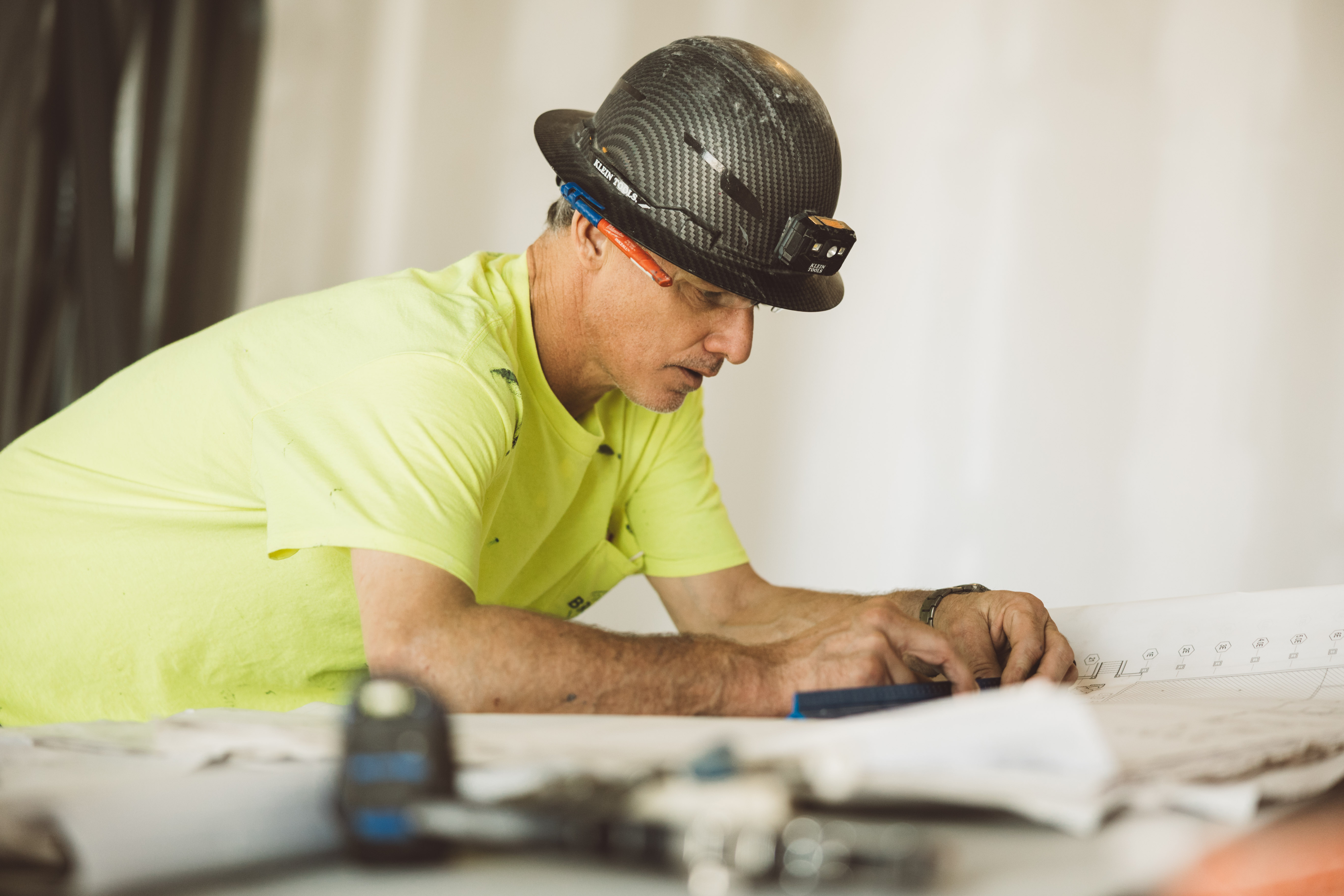 Ethos foreman studying blueprints